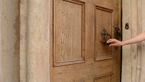 Woman Uses Door Knocker