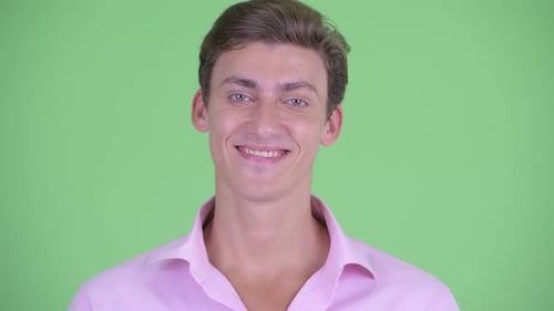 Young Man Smiling Portrait on Green Background