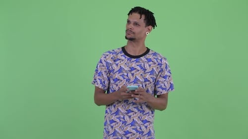 Man Uses Mobile Phone and Smiles on Green Screen