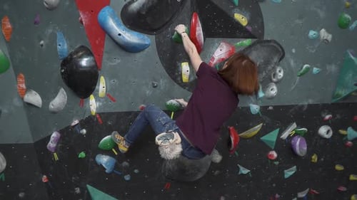 Woman Climbing Indoor Rock Climbing Wall