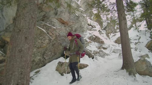 Hiker Walking Down Steep Rocky Trail in Winter