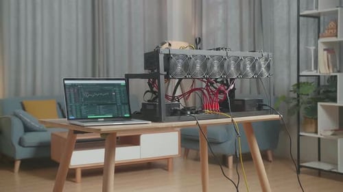 Laptop Showing Crypto Chart And Mining Rig On The Table For Mining Cryptocurrency