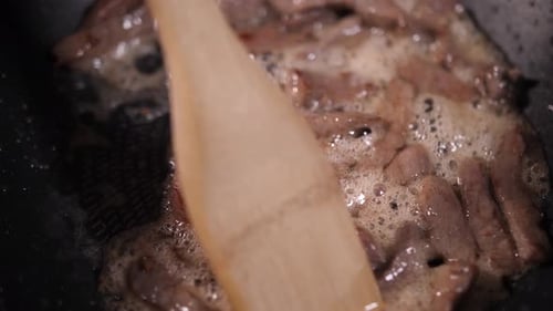 Beef Strips Cooking in Frying Pan Close Up