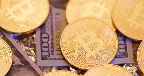 Golden Bitcoins Stacked on Hundred Dollar Bill