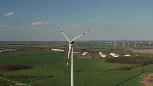 AERIAL: Close Up Shot of Wind Turbine, Mill Rotating By the Force of the Wind Generating Renewable