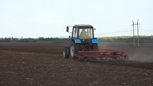 Tractor plows the farm field