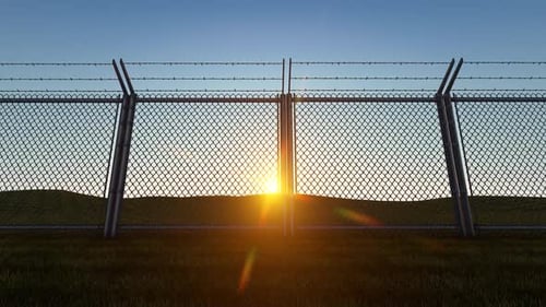 Barbed Wire Fence with Rising Sun
