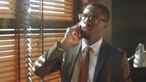 Black Businessman Talking on Mobile Phone in Office