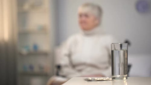 Upset Elderly Woman in Wheelchair Thinking About Fatal Diagnosis Hospital Care