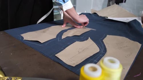 Person Marking Fabric with Chalk for Sewing Project