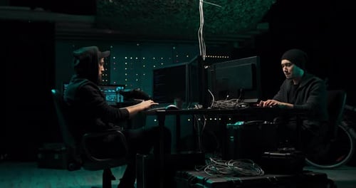 Two Hackers Coding at Computers Late at Night