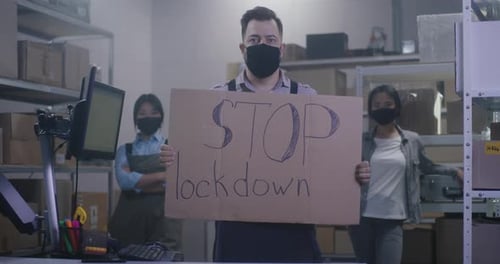 People with Sign in Warehouse with Boxes