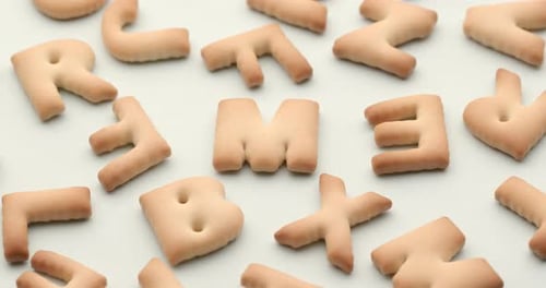 Alphabet Cracker Letters on White Background Panning Shot