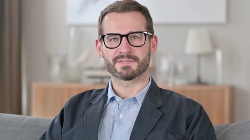Smiling Man Waving and Talking to the Camera