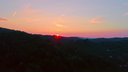Aerial View of Forested Mountains at Sunrise