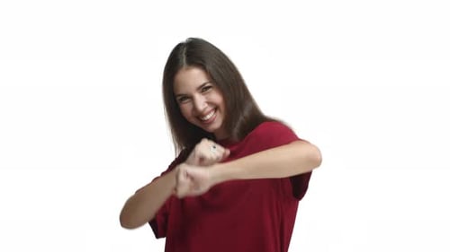 Cheerful Woman Dancing and Celebrating Against White Background