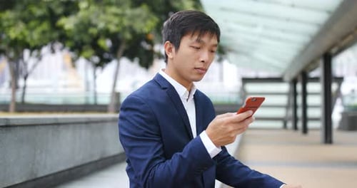 Young Adult Using Mobile Phone in Urban Setting
