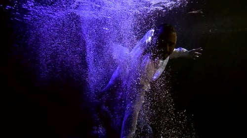 Man Is Sinking in Dark Water, View From Depth, Moving Hands and Swimming