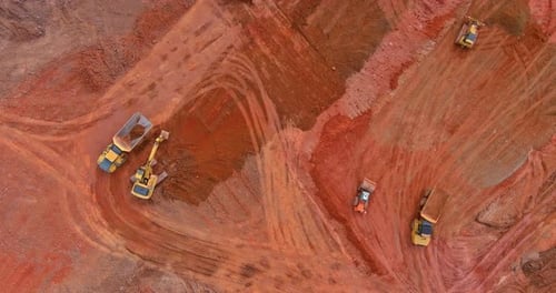 Aerial Top Down View of an Excavator Loading Earth Into a Dump Truck
