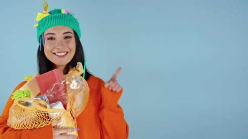 Young Woman Holding Recycling Points to Copy Space