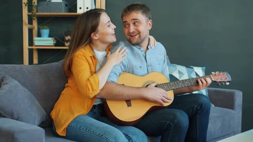 Couple Singing Song With Acoustic Guitar