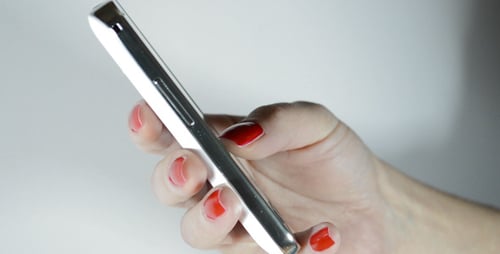 Hand Holding a White Smartphone at an Angle