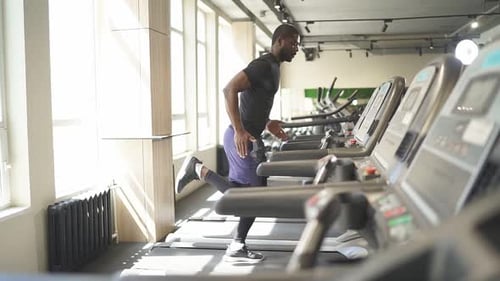 Sportsman Training on Treadmill They Are Concentrated on Running in Fitness Gym