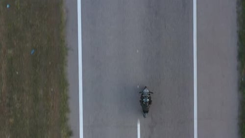 Top View to Biker Riding on Modern Sport Motorbike at Highway
