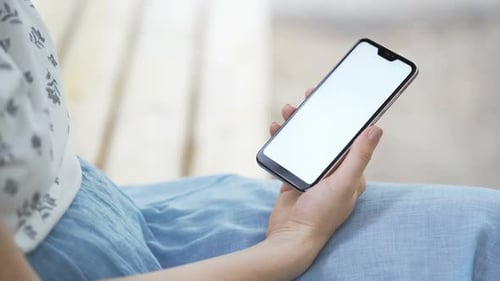 Woman Holding Smartphone with Blank Screen Indoors