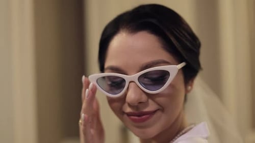 Smiling Woman in Retro Sunglasses and Pearl Necklace