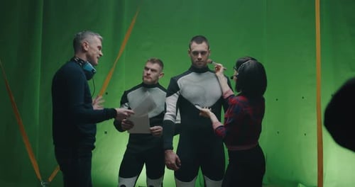 Film Crew Prepares Actors on Green Screen Set