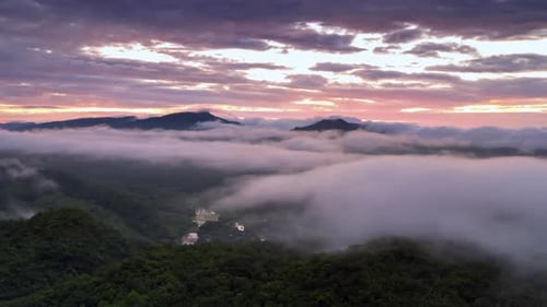 Breathtaking Aerial View of Mountains Covered in Clouds