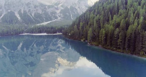 Aerial Drone Flight Establisher Over Lake with Clouds and Forest