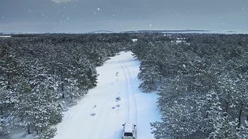 Bird's Eye View of Car Driving on Countryside Off Road on Winter Vacation Getaway