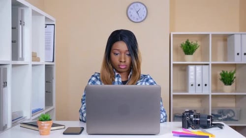 Woman Working on Laptop at Office Desk