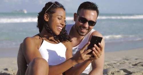 Happy Diverse Couple Taking Selfie on Beach