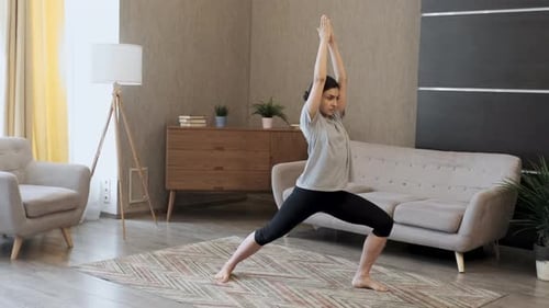 Woman Does Yoga in Living Room