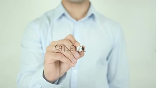 Man Writing the Word Patience with Marker