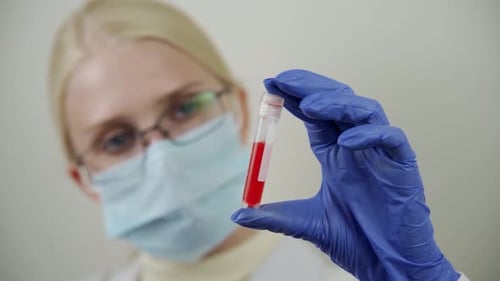 Healthcare Worker Holding Test Tube with Blood Sample