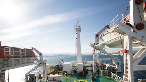 Ship Transports Cargo into Harbor on Sunny Day