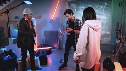 Actors Discussing Scripts in Colourful Urban Space