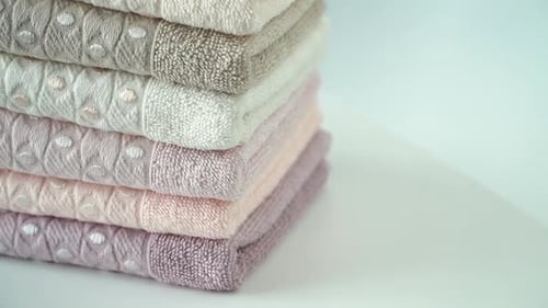 Stack of Folded Pastel Towels on White Surface