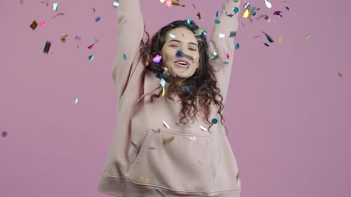 Excited Woman Throws Confetti in Celebration