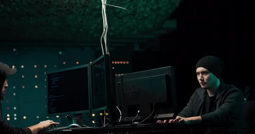 Coders Typing at Computers Celebrate a Successful Project