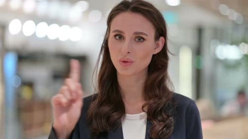 Woman Waving Finger Saying No Indoors