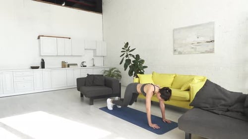 Athletic Woman Doing Mountain Climber Exercise at Home