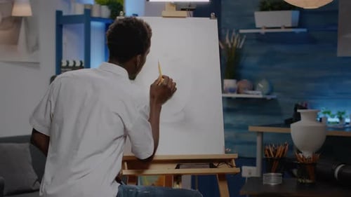 Artist Drawing on a Canvas in Studio