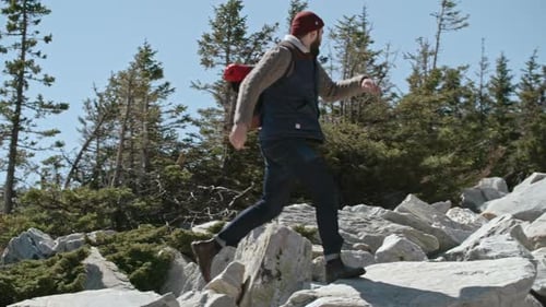 Tourist Jumping from Rock to Rock