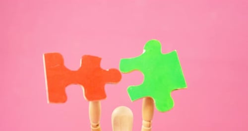 Wooden Mannequin Holding Connecting Puzzle Pieces