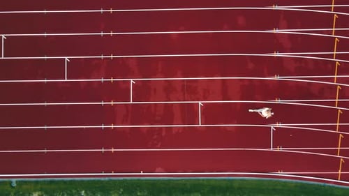 Aerial Top View of Athlete Running at Marathon Stadium